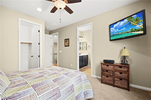 bedroom featuring visible vents, connected bathroom, baseboards, light carpet, and a ceiling fan