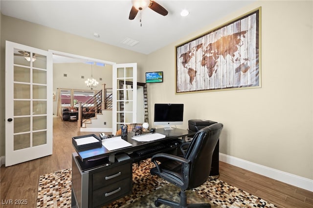 office featuring visible vents, baseboards, ceiling fan with notable chandelier, french doors, and wood finished floors