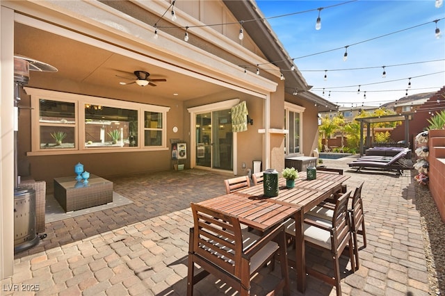 view of patio with outdoor dining area and a ceiling fan