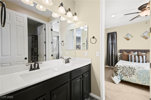 full bathroom featuring double vanity, baseboards, a ceiling fan, and a sink