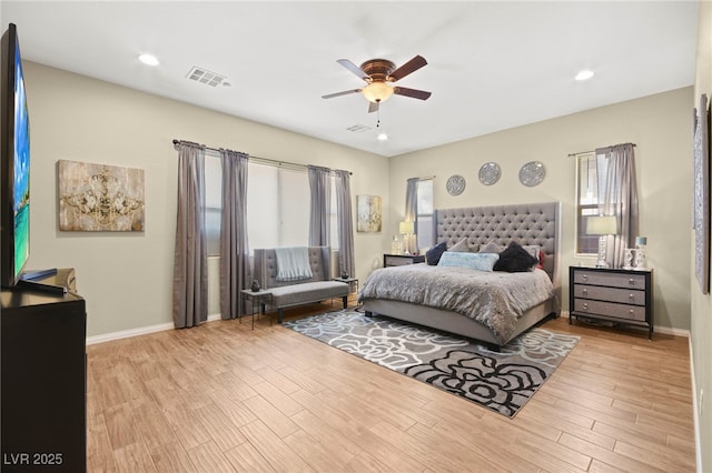 bedroom with visible vents, baseboards, wood finished floors, and a ceiling fan