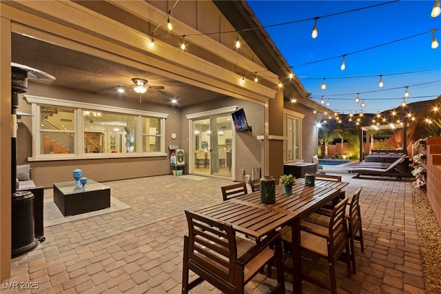 view of patio featuring outdoor dining space, an outdoor pool, and ceiling fan