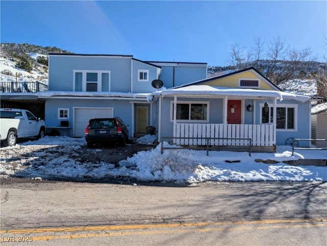 view of front of property with covered porch and a garage