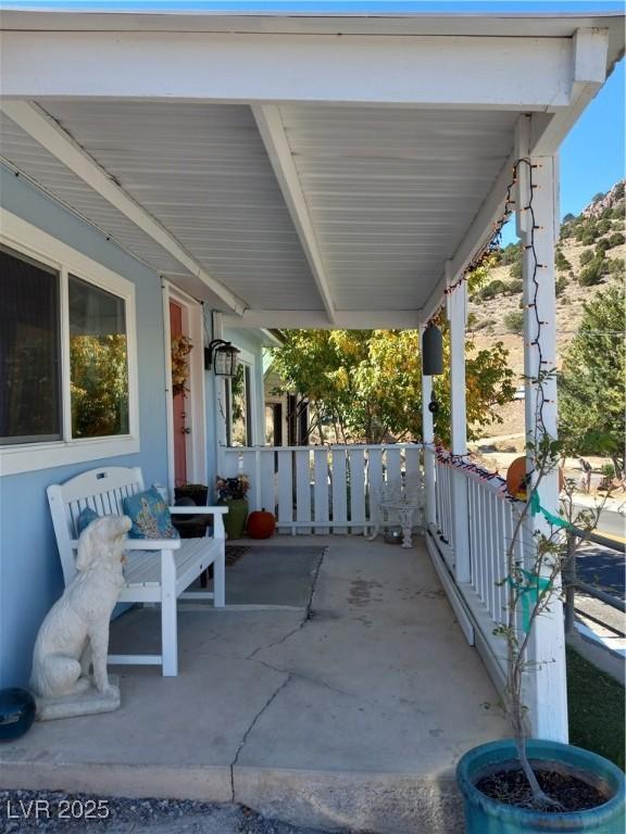 view of patio / terrace with a carport and a porch