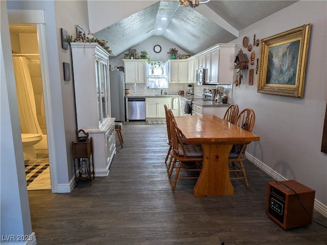 dining area featuring dark wood finished floors, vaulted ceiling, recessed lighting, and baseboards