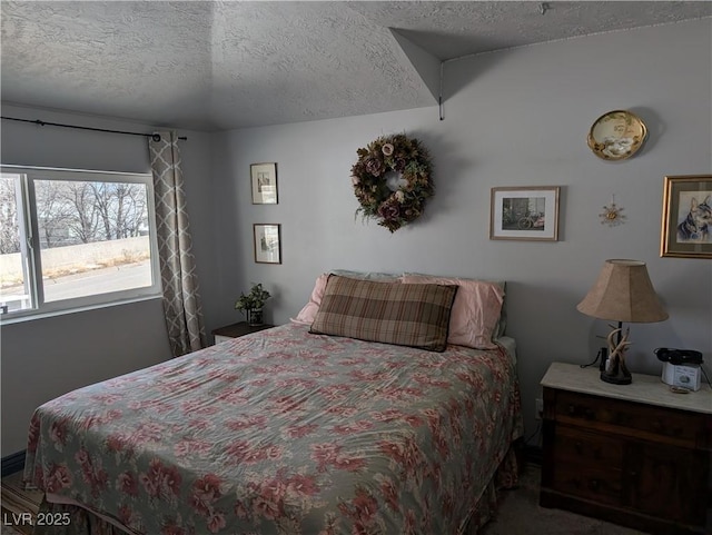 bedroom featuring carpet floors and a textured ceiling