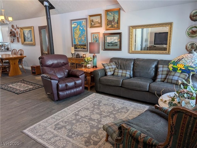 living area with a wood stove, wood finished floors, and baseboards