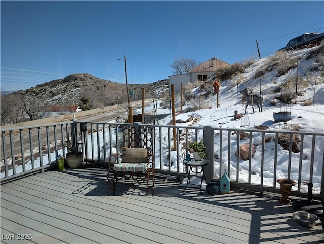 snow covered deck featuring a mountain view