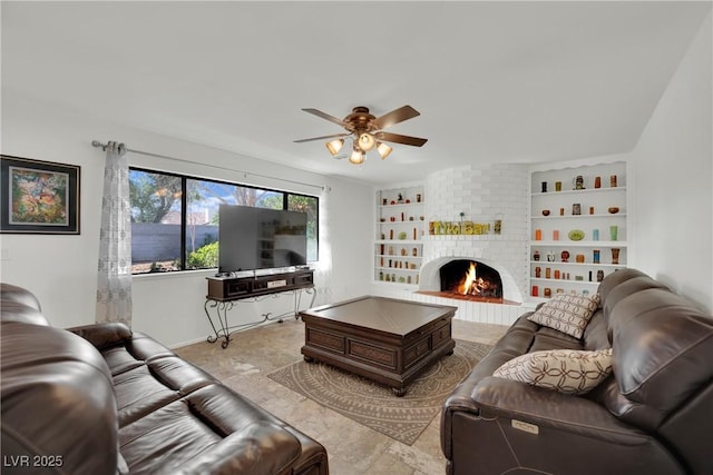 living area with a brick fireplace, a ceiling fan, and built in features