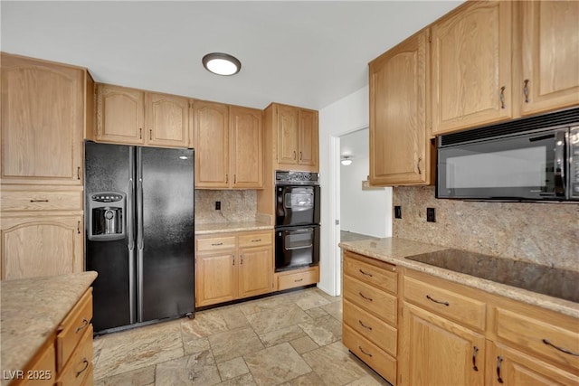 kitchen with black appliances, light brown cabinets, stone finish floor, and backsplash