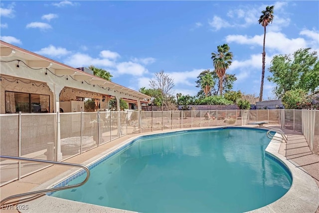 view of swimming pool featuring a patio area, fence, and a fenced in pool