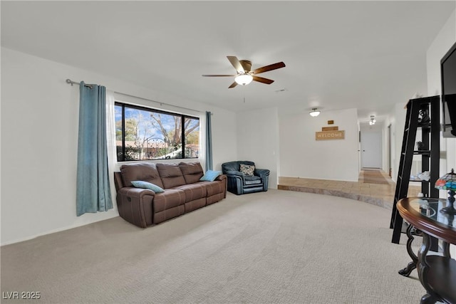 living room featuring a ceiling fan and carpet flooring