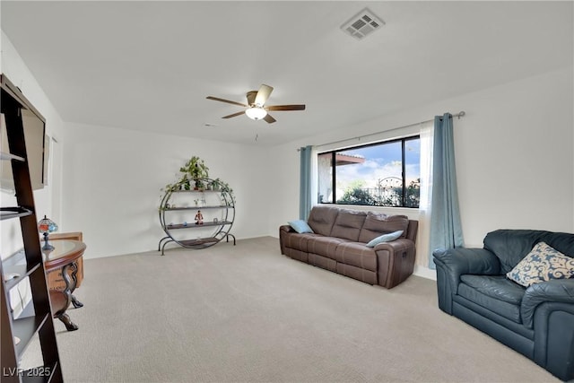 living room featuring carpet floors, visible vents, and ceiling fan