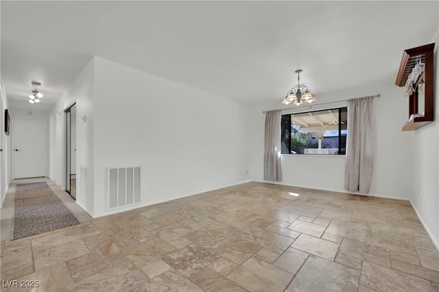 3681 S Rosecrest Cir, Las Vegas, NV 89121 - empty room featuring stone tile floors and a chandelier