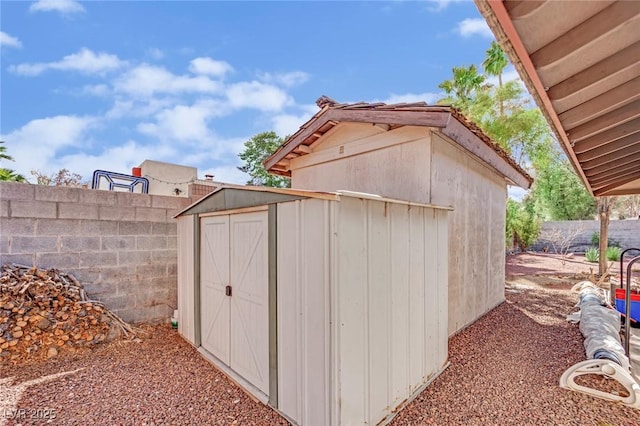 view of shed featuring fence