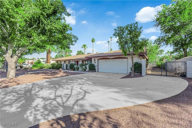 3681 S Rosecrest Cir, Las Vegas, NV 89121 - ranch-style home with concrete driveway, stucco siding, a garage, a gate, and a tile roof