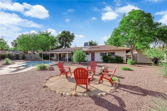 3681 S Rosecrest Cir, Las Vegas, NV 89121 - back of property featuring a patio, a tiled roof, a fire pit, stucco siding, and an outbuilding