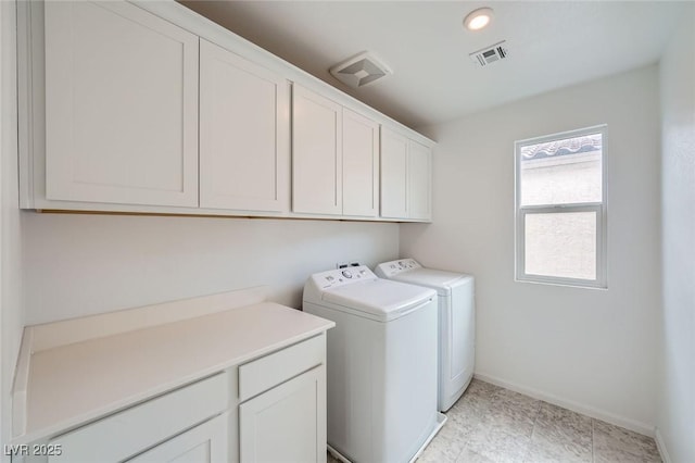 laundry room featuring baseboards, cabinet space, visible vents, and washing machine and clothes dryer