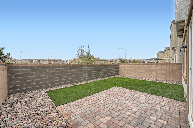 view of yard with a patio area and a fenced backyard