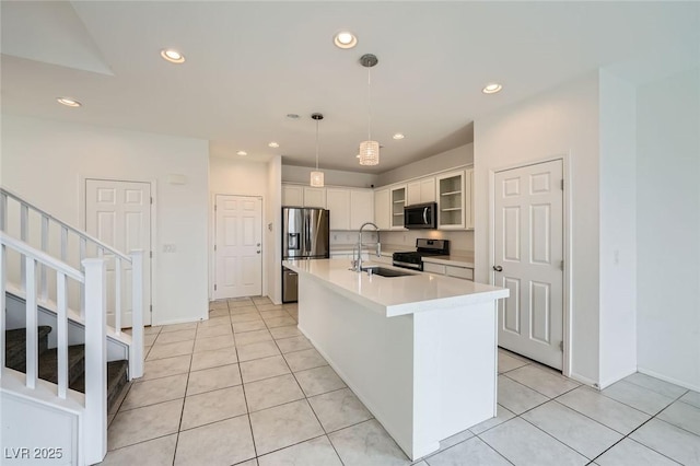 kitchen with recessed lighting, stainless steel appliances, a sink, white cabinets, and light countertops