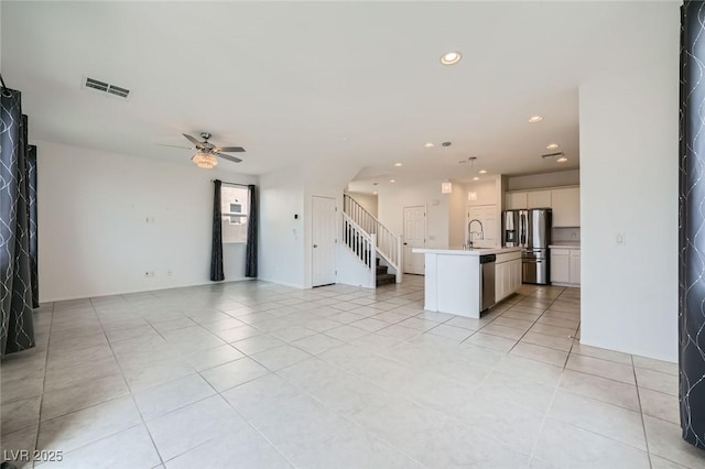 unfurnished living room with recessed lighting, visible vents, stairway, and light tile patterned flooring