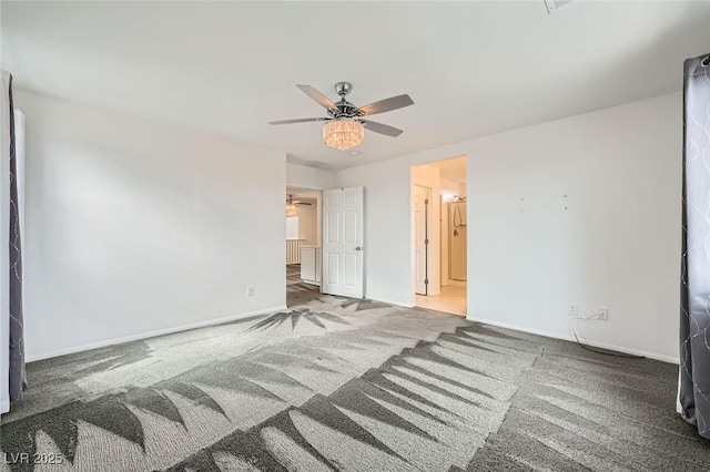 unfurnished bedroom featuring carpet, connected bathroom, a ceiling fan, and baseboards