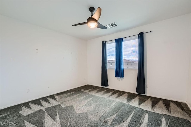 empty room with carpet floors, ceiling fan, visible vents, and baseboards