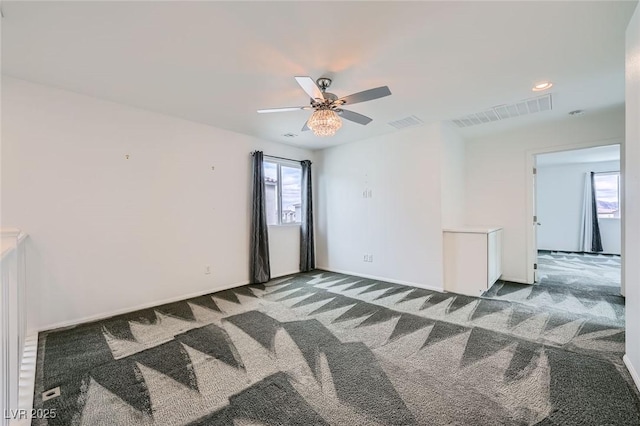 unfurnished room featuring baseboards, carpet, visible vents, and a ceiling fan