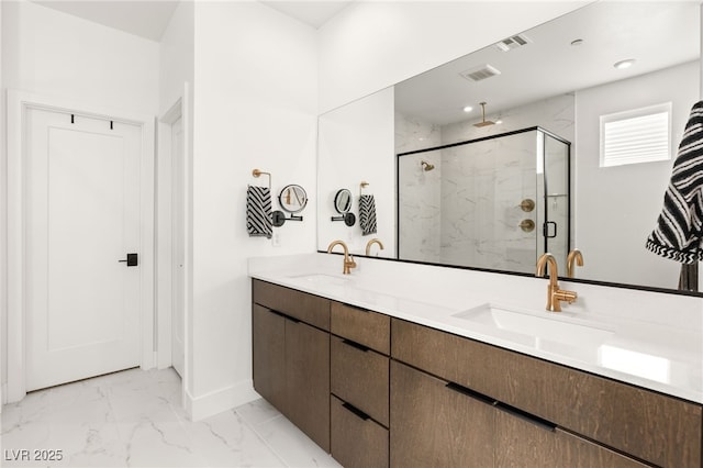 bathroom featuring marble finish floor, visible vents, a sink, and a marble finish shower