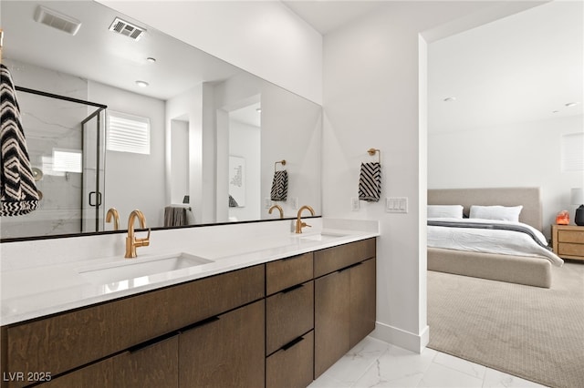 ensuite bathroom featuring marble finish floor, a stall shower, a sink, and visible vents