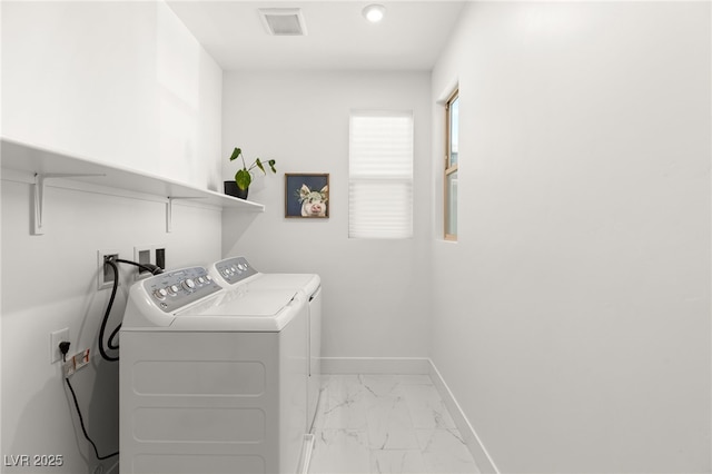 washroom with laundry area, visible vents, baseboards, marble finish floor, and washer and clothes dryer