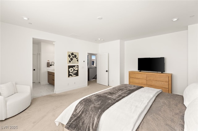 bedroom with ensuite bath, recessed lighting, baseboards, and light colored carpet