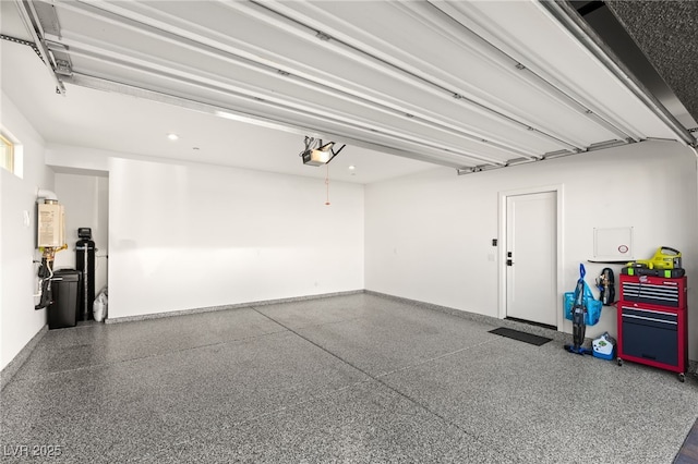 garage with water heater, baseboards, and a garage door opener