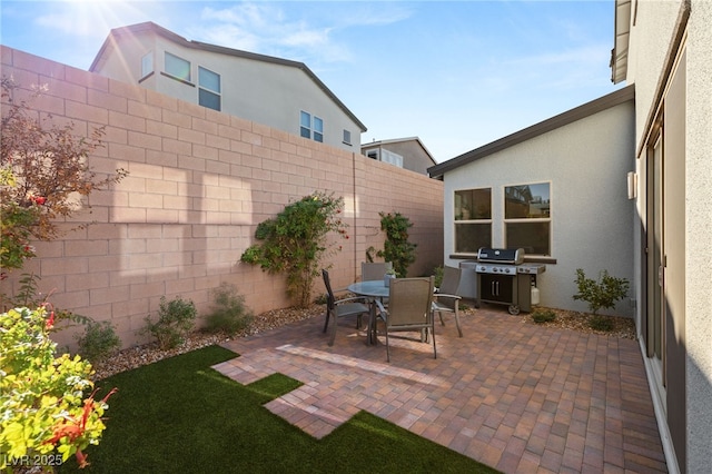 view of patio / terrace with outdoor dining area, grilling area, and a fenced backyard