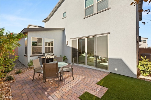 back of property with a patio, central AC unit, outdoor dining area, and stucco siding