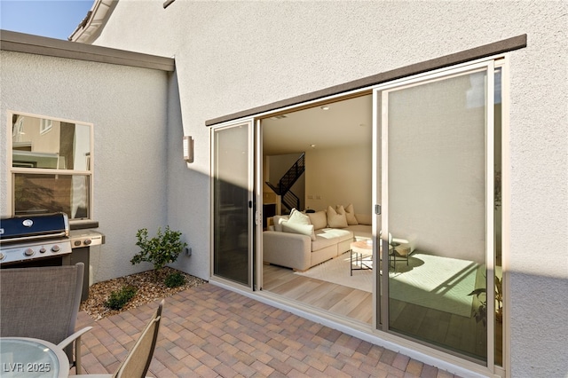 exterior space with a patio area and stucco siding