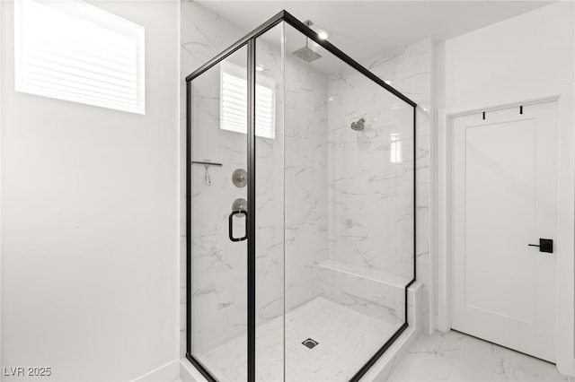 bathroom featuring marble finish floor and a marble finish shower