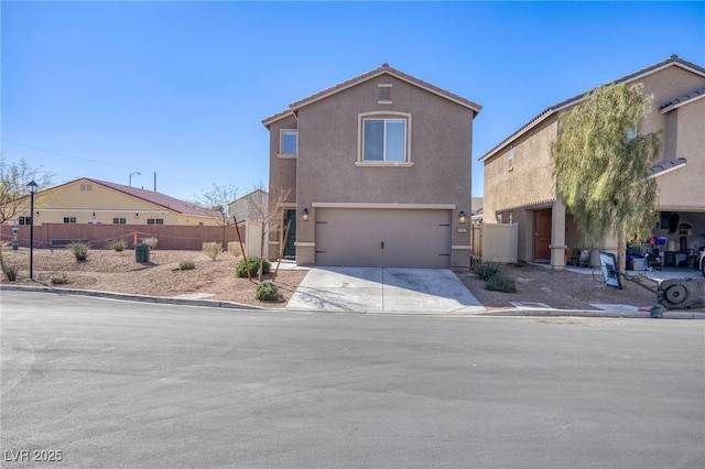 view of front of property featuring driveway, an attached garage, fence, and stucco siding