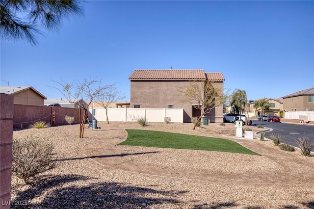 view of yard featuring fence and a residential view