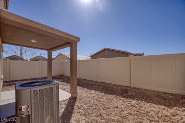 view of yard with cooling unit and a fenced backyard