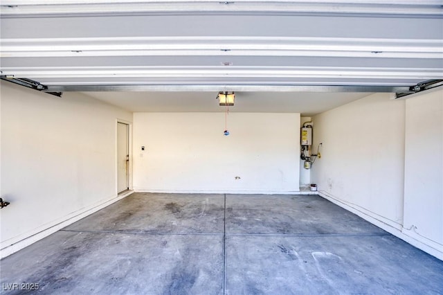 garage featuring water heater and a garage door opener