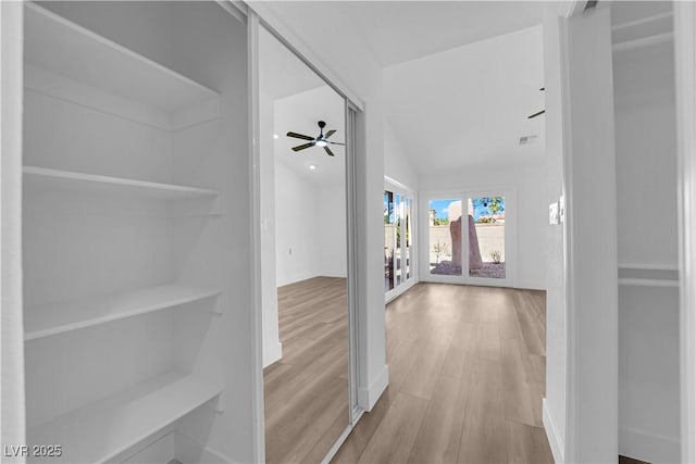 hallway featuring wood finished floors and visible vents