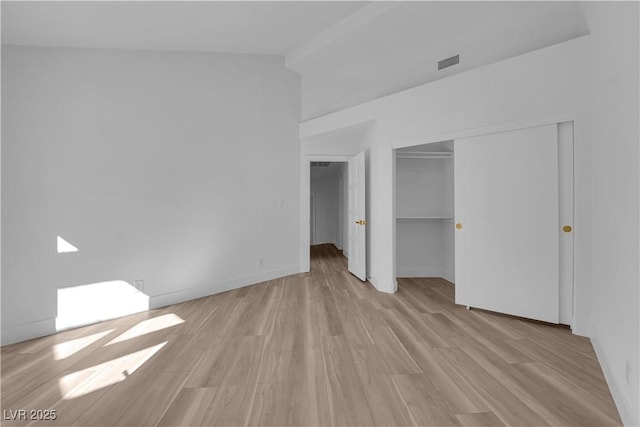 unfurnished bedroom with a closet, light wood-type flooring, visible vents, and baseboards