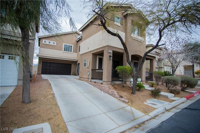 view of front of home featuring stucco siding, a garage, and driveway