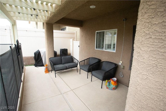 view of patio featuring fence and a pergola