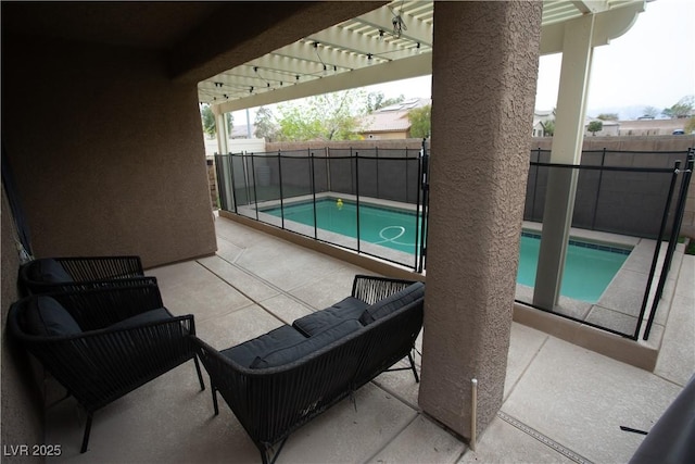 view of pool with a fenced in pool, a fenced backyard, outdoor lounge area, and a patio area