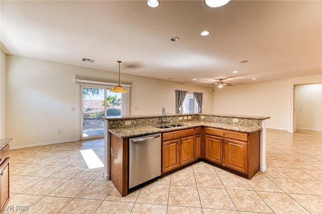 kitchen with light tile patterned floors, brown cabinetry, visible vents, a sink, and stainless steel dishwasher