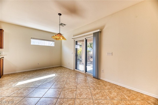 unfurnished dining area featuring light tile patterned floors, visible vents, and baseboards