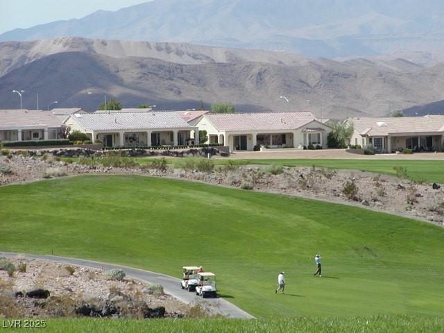 view of community featuring a lawn and a mountain view