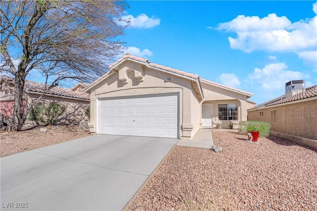 view of front of house featuring driveway, an attached garage, a tiled roof, and stucco siding